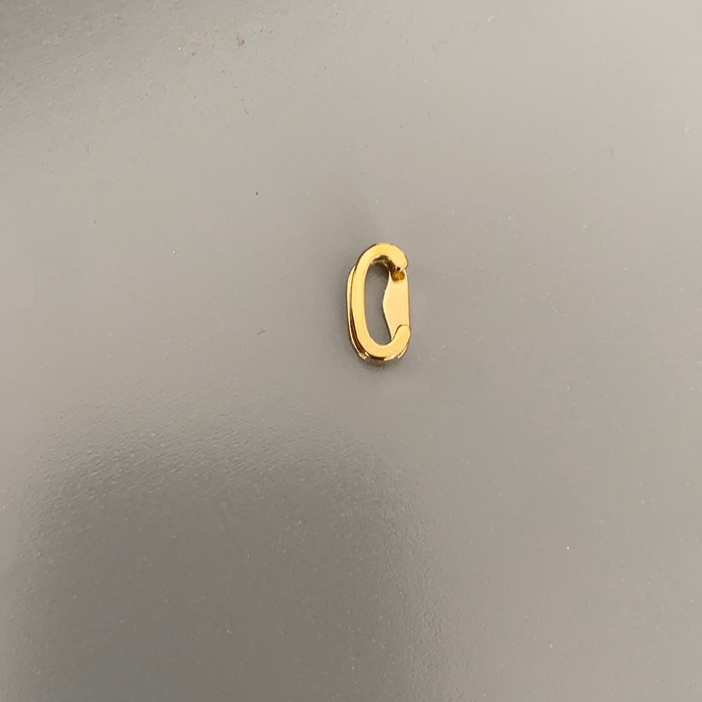 Keep collective gold “C” charm